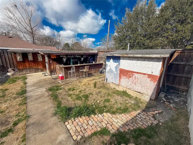 a view of a backyard with furniture and a fire pit
