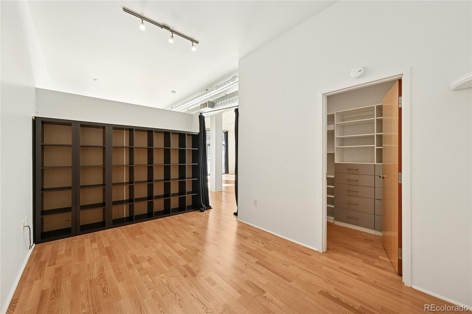 3100 Huron Street, Unit 2C Denver, CO 80202 - Photo 14 of 18 a view of an empty room with wooden floor and a window