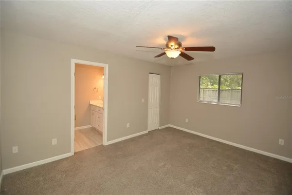 a view of a big room with chandelier fan