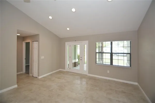 an empty room with a empty space and windows