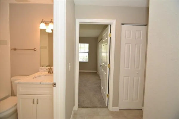 a en suite bathroom with a granite countertop sink and a mirror