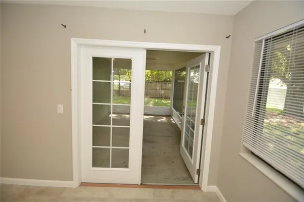 a view of a walk in closet with wooden floor and a large window