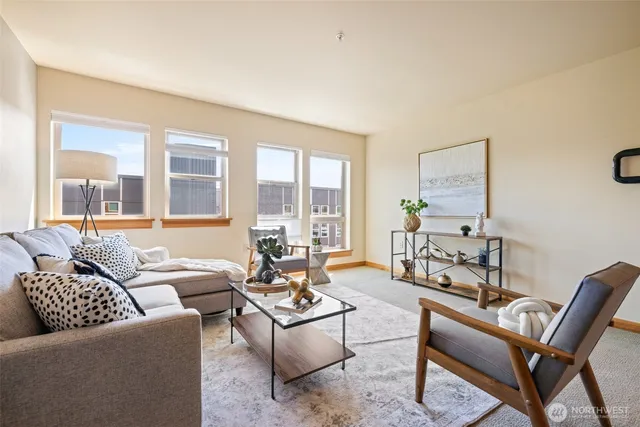 a living room with furniture and a floor to ceiling window