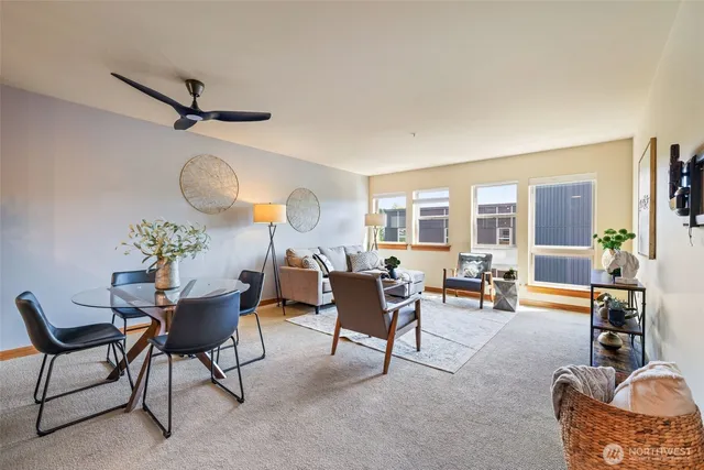 a living room with furniture a rug and a large window