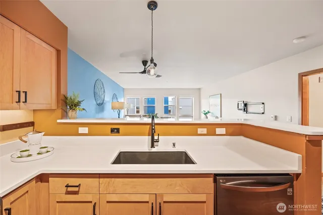 a kitchen with a sink a counter and chairs