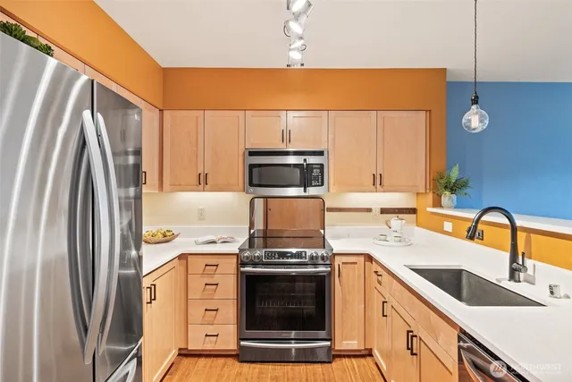 a kitchen with a stove and a refrigerator