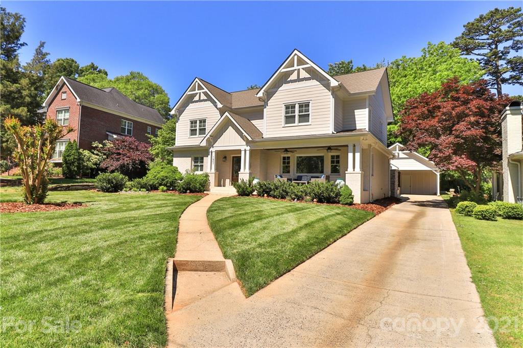 1901 Truman Road Charlotte, NC 28205 - Photo 2 of 39 a front view of a house with a yard and potted plants