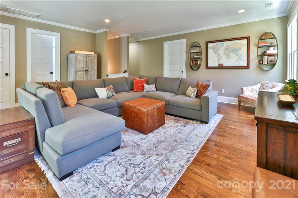 1901 Truman Road Charlotte, NC 28205 - Photo 22 of 39 a living room with furniture or couch and paintings on the wall