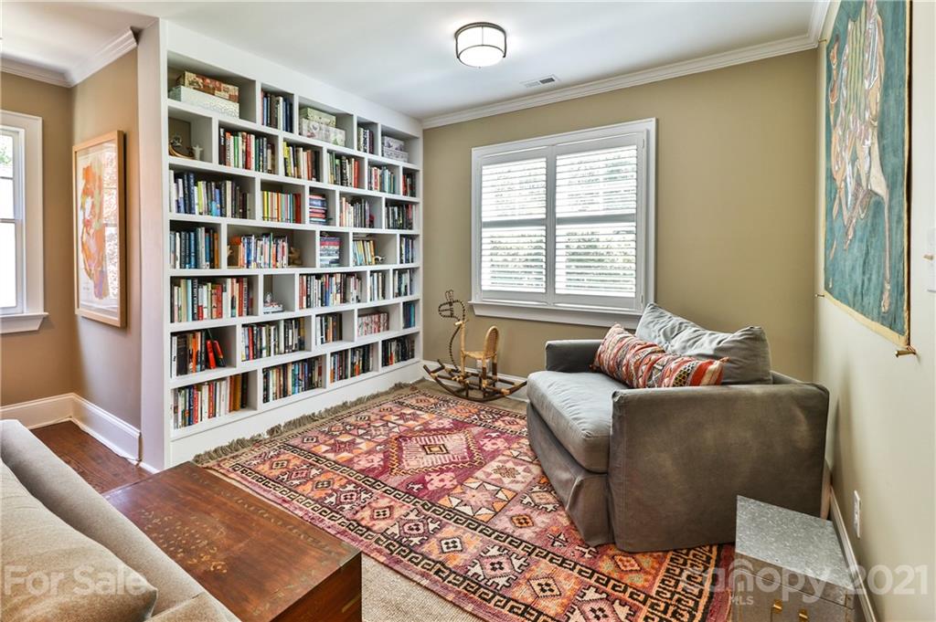 1901 Truman Road Charlotte, NC 28205 - Photo 24 of 39 a living room with a couch and a bookshelf