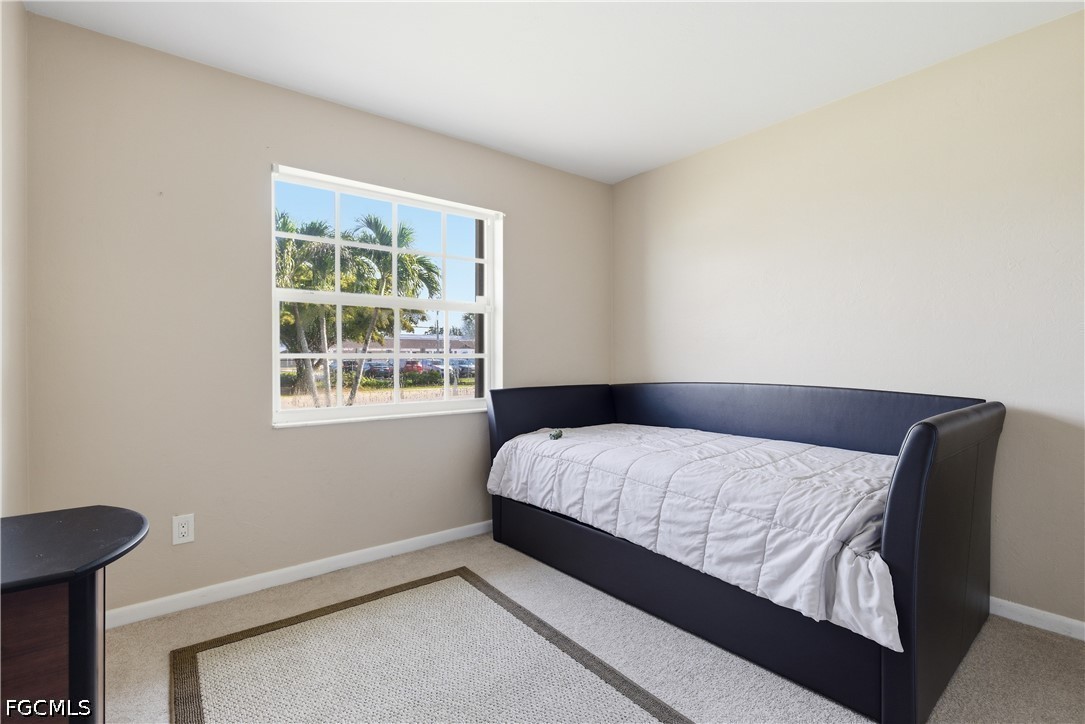 4960 20th Place Southwest Naples, FL 34116 - Photo 17 of 33 a bedroom with a bed and window