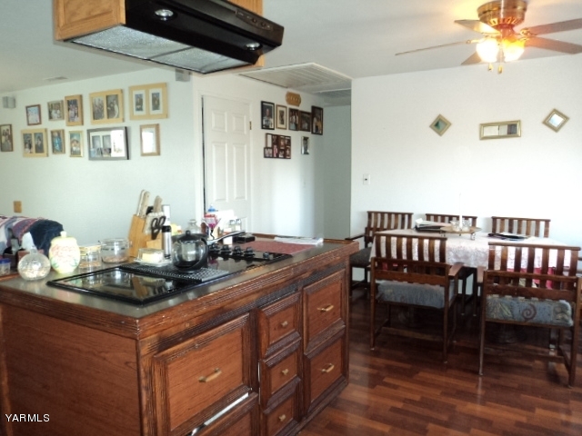 6701 East Beauchene Road Moxee, WA 98936 - Photo 5 of 27 a kitchen with a table chairs and wooden floor