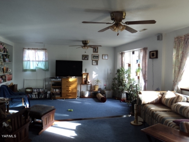 6701 East Beauchene Road Moxee, WA 98936 - Photo 7 of 27 a living room with furniture and a flat screen tv