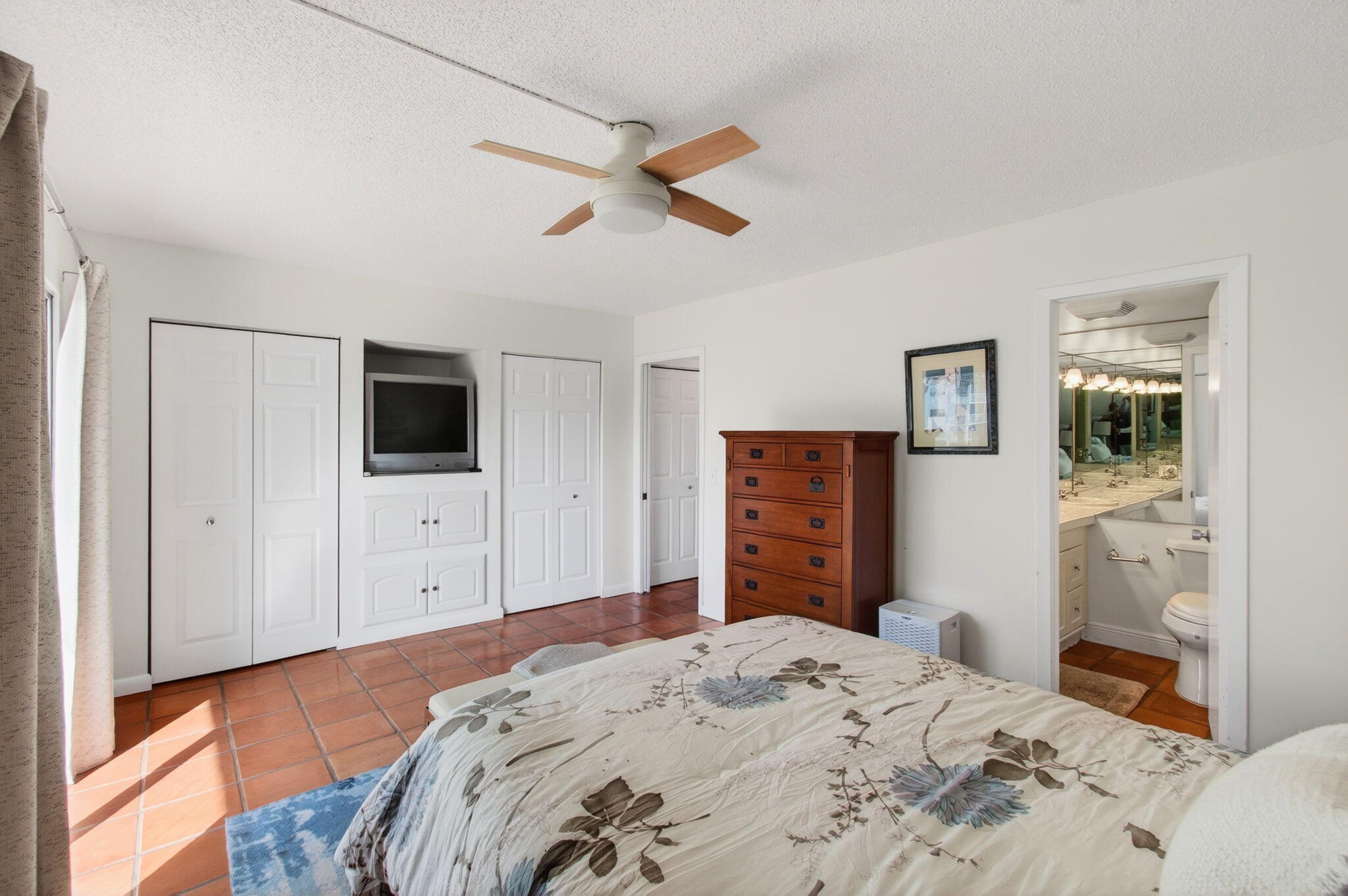 359 Brighton I Boca Raton, FL 33434 - Photo 16 of 34 a bedroom with a bed and a flat screen tv