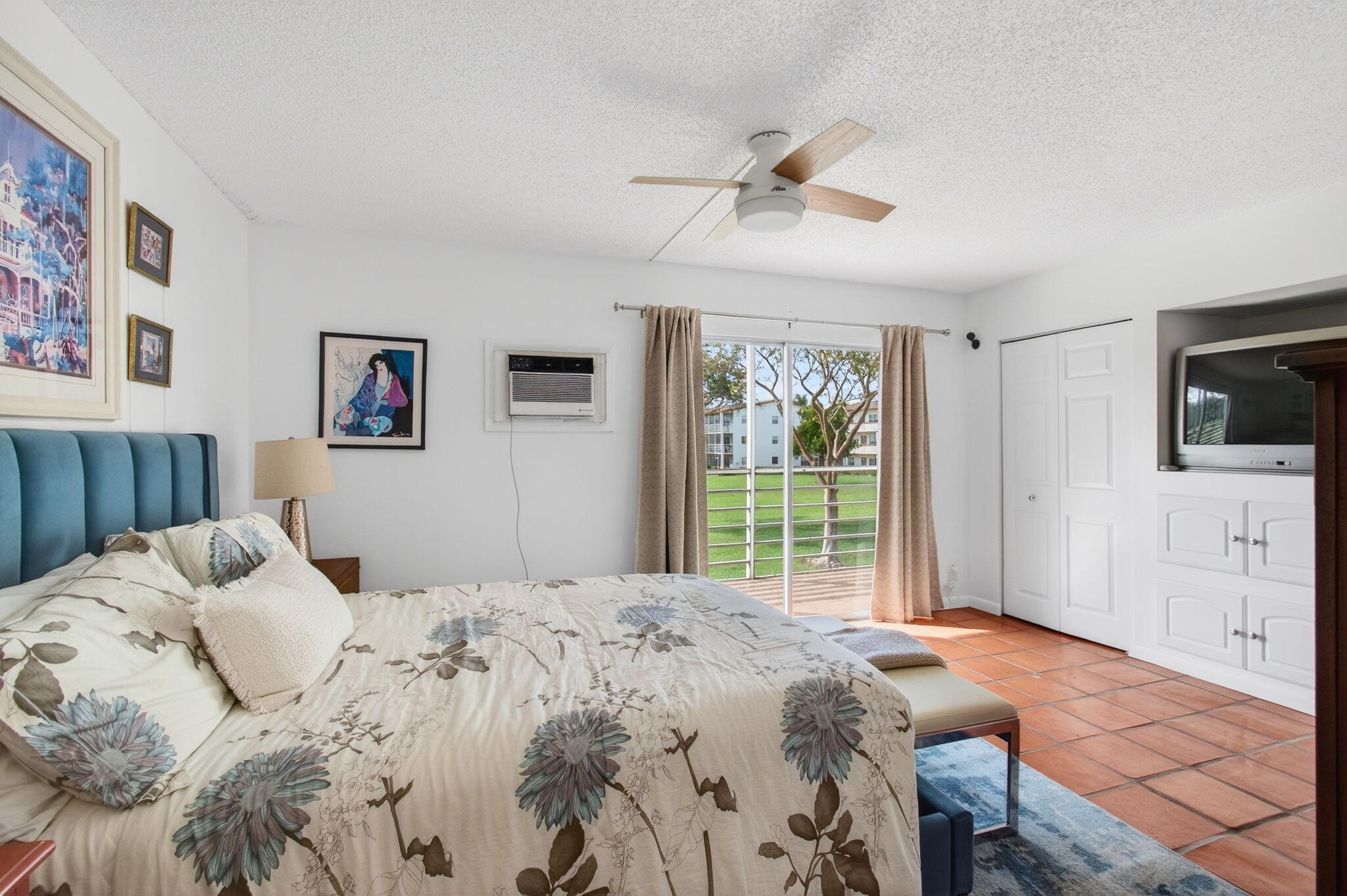 359 Brighton I Boca Raton, FL 33434 - Photo 17 of 34 a bedroom with a large bed and a flat tv screen