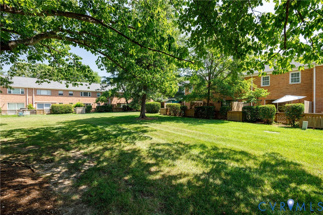 9129 Derbyshire Road, Unit E Henrico, VA 23229 - Photo 33 of 36 Expansive green space featuring a manicured lawn,