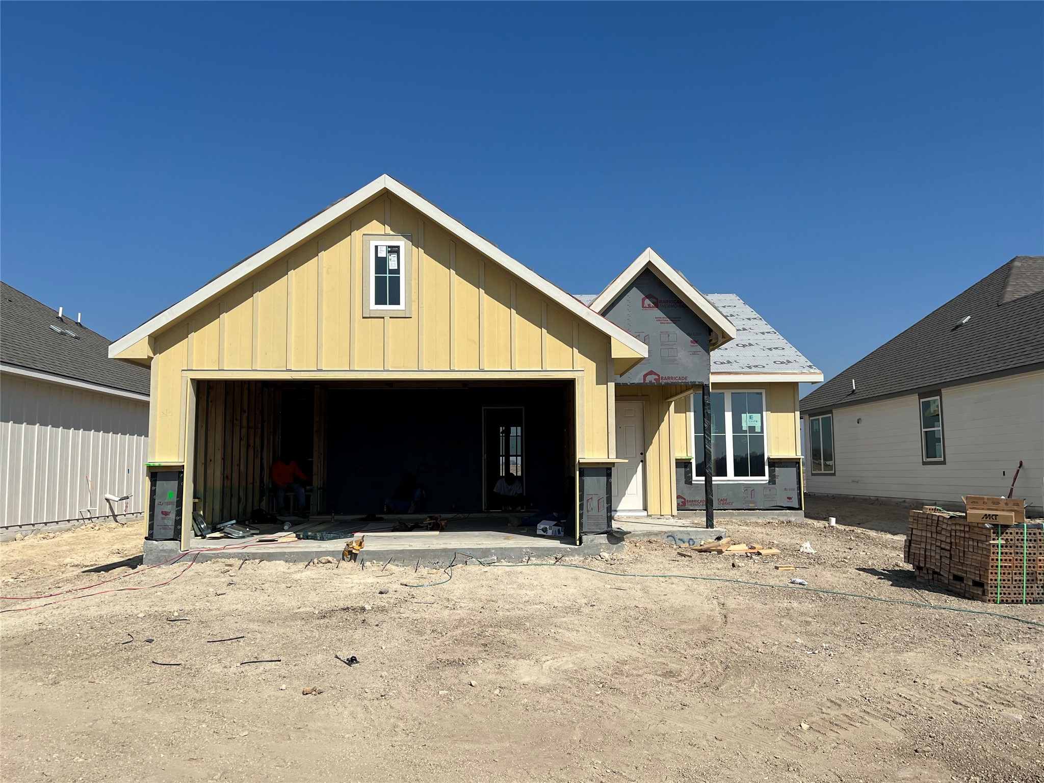 228 Gus Loop Georgetown, TX 78626 - Photo 1 of 16 Unfinished property with board and batten siding and a garage