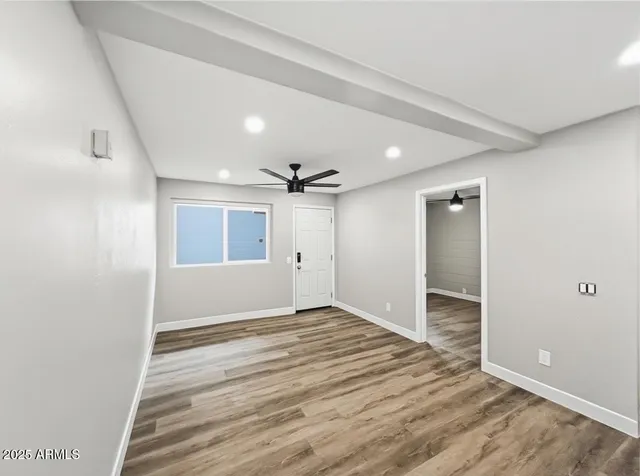 wooden floor in an empty room with a window