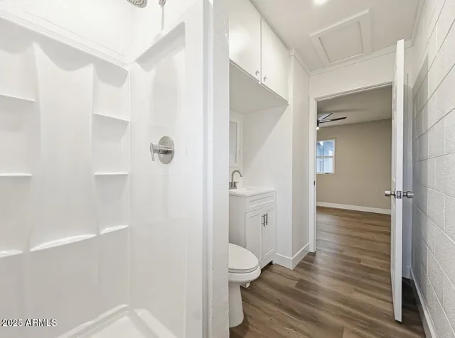 a bathroom with a toilet and a shower