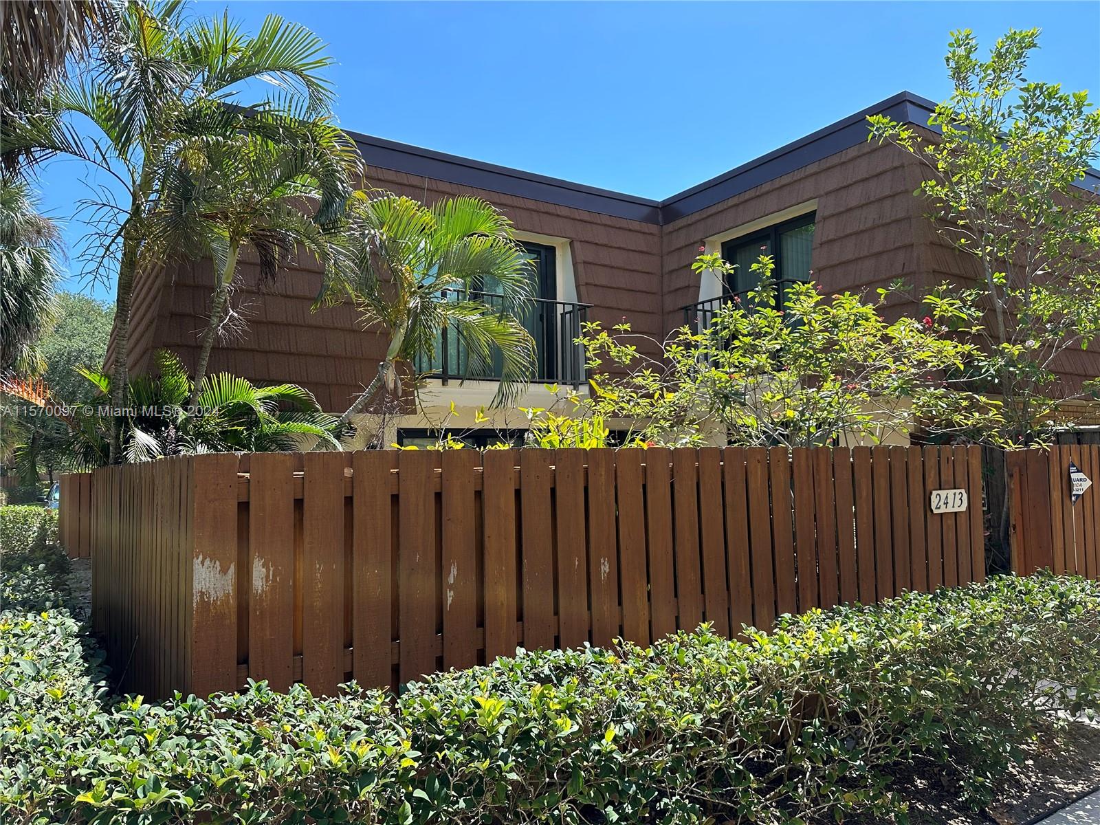 2413 24th Court Jupiter, FL 33477 - Photo 1 of 32 a view of small garden with wooden fence