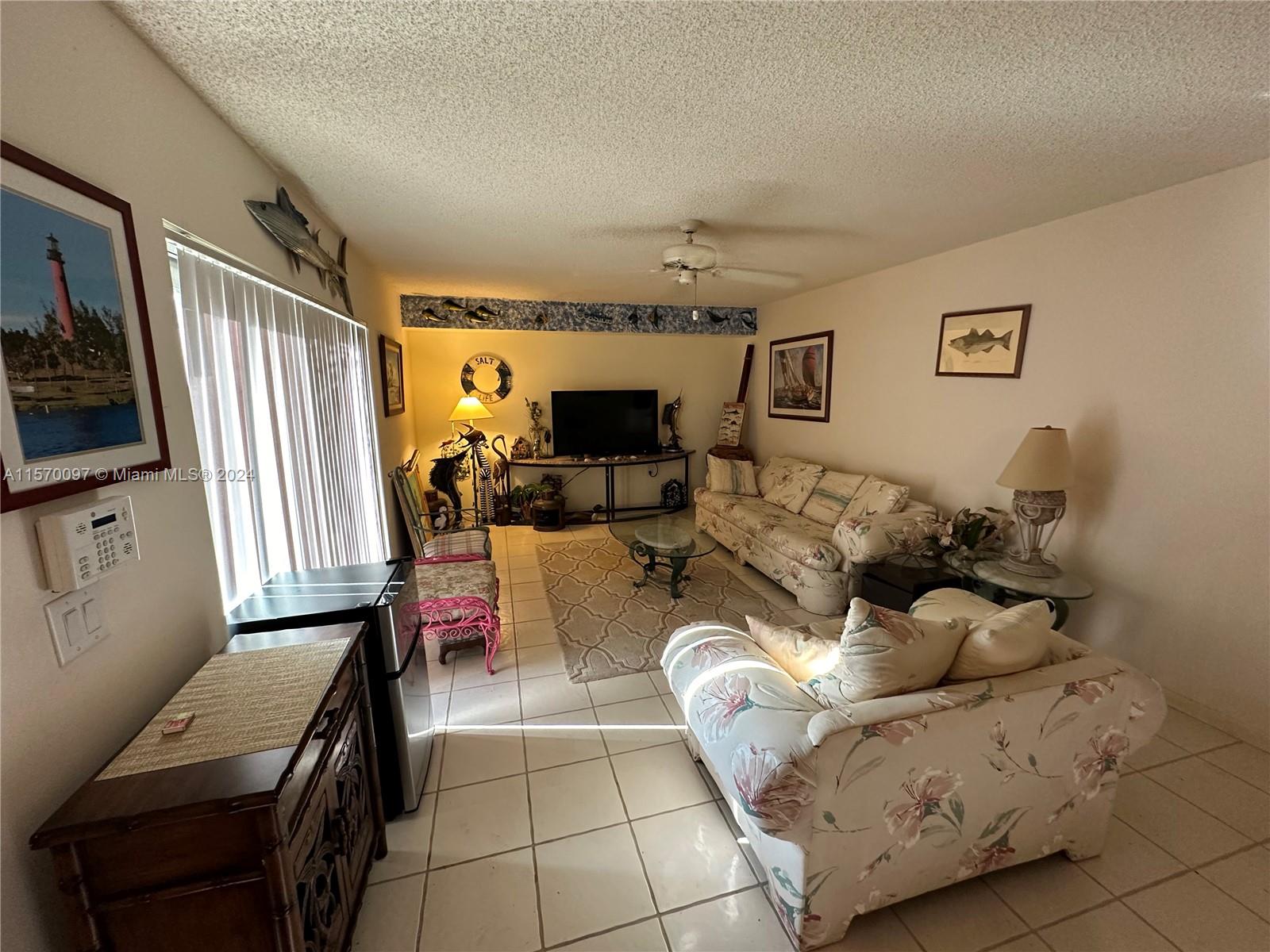 2413 24th Court Jupiter, FL 33477 - Photo 11 of 32 a living room with furniture chess board and a flat screen tv