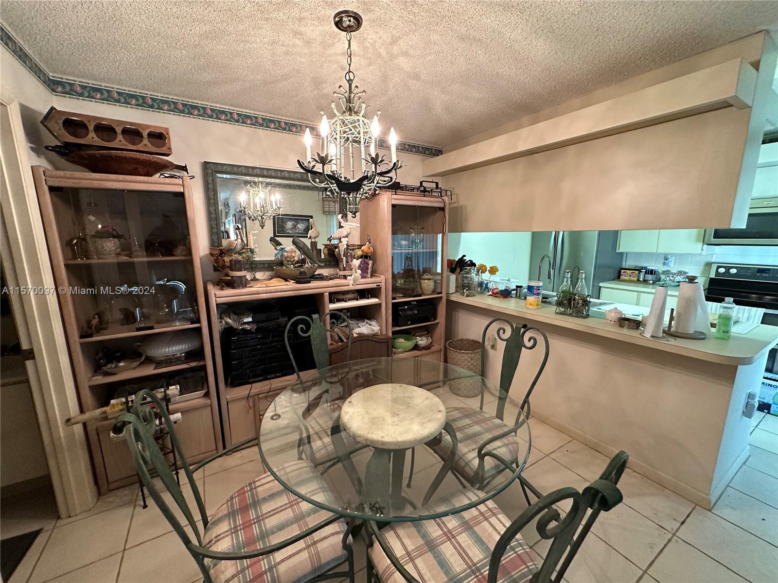 2413 24th Court Jupiter, FL 33477 - Photo 12 of 32 a dining room filled with furniture and kitchen view