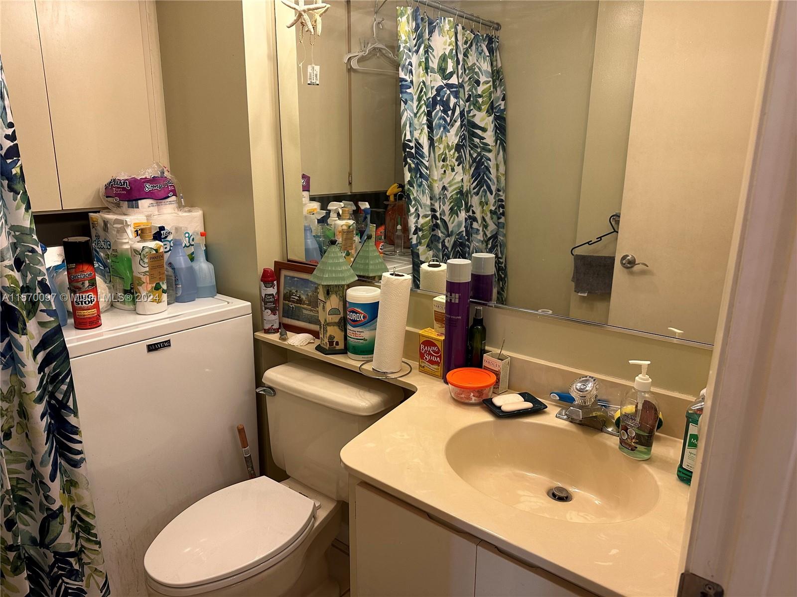 2413 24th Court Jupiter, FL 33477 - Photo 20 of 32 a bathroom with a sink vanity mirror and toilet