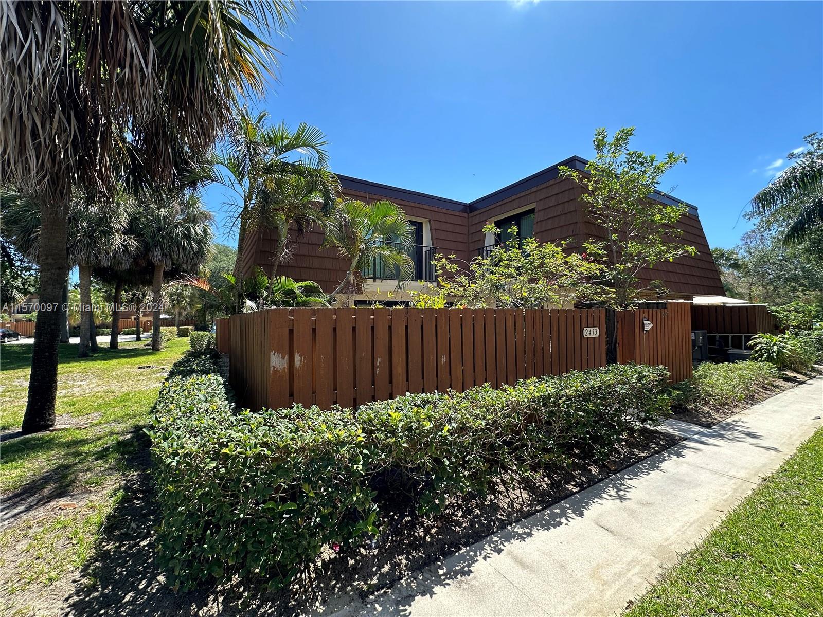 2413 24th Court Jupiter, FL 33477 - Photo 2 of 32 a view of a garden with pathway