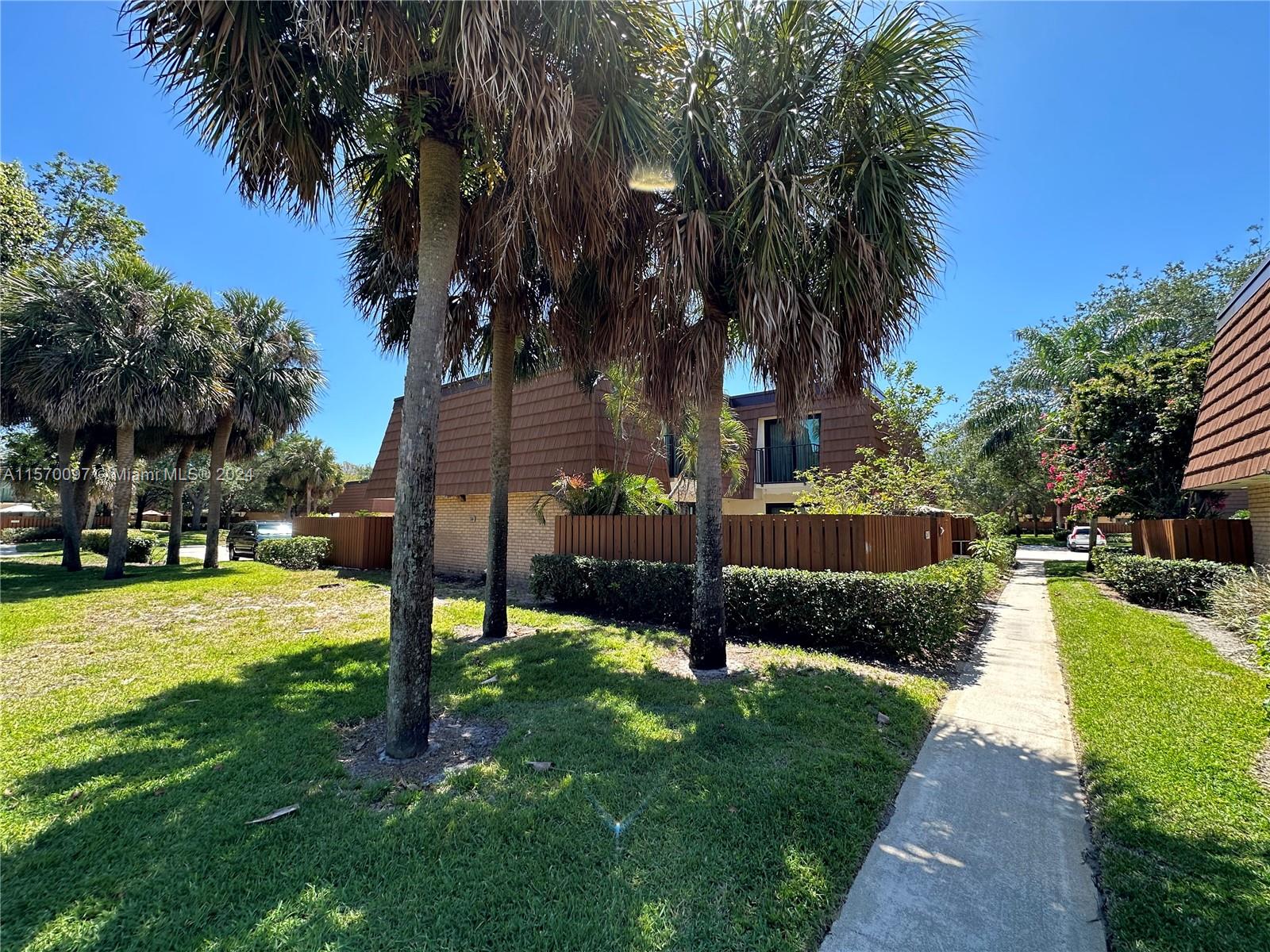2413 24th Court Jupiter, FL 33477 - Photo 29 of 32 a view of a backyard with swimming pool