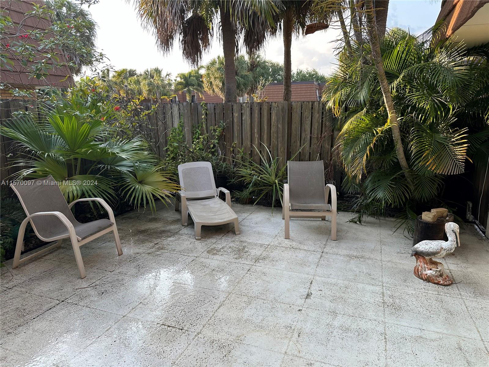2413 24th Court Jupiter, FL 33477 - Photo 4 of 32 a view of a chairs and tables in the patio