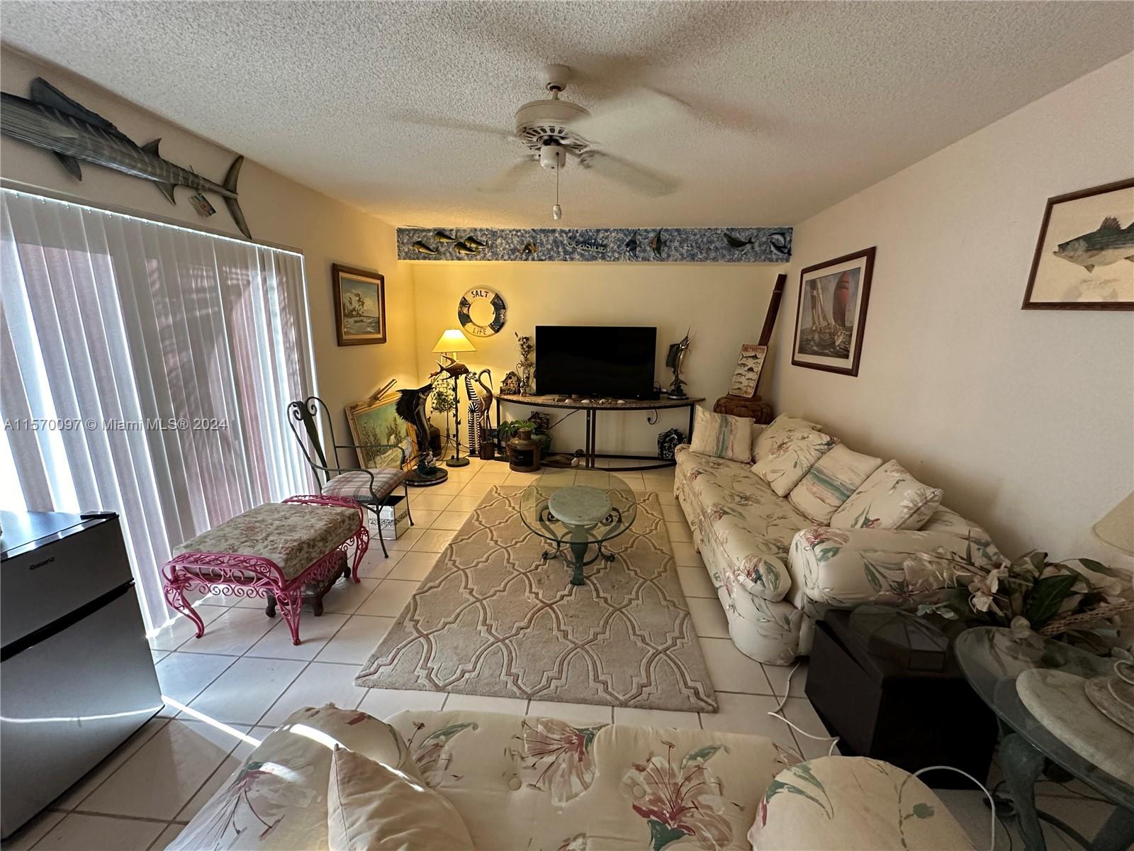 2413 24th Court Jupiter, FL 33477 - Photo 8 of 32 a living room with furniture and a flat screen tv