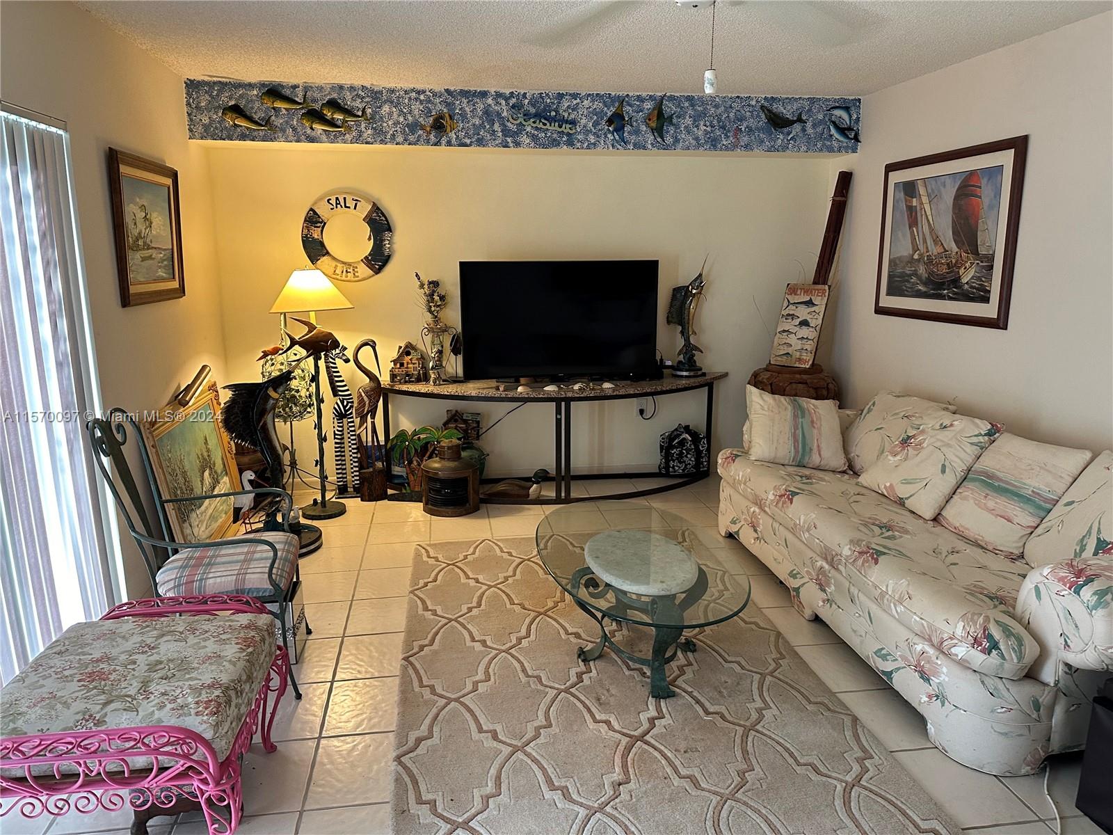 2413 24th Court Jupiter, FL 33477 - Photo 10 of 32 a living room with furniture and a flat screen tv