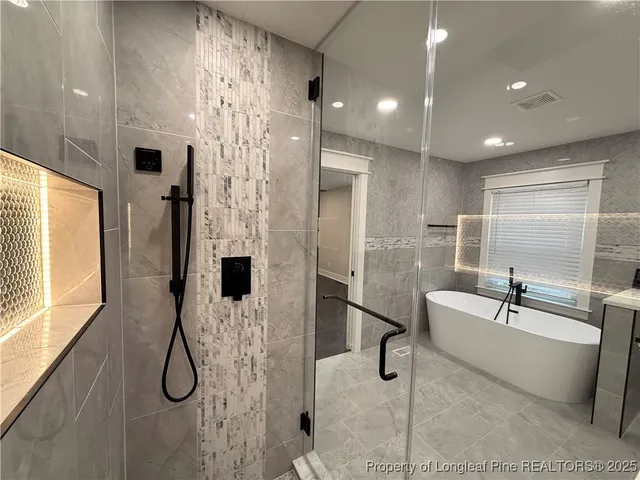 a bathroom with a bathtub and a shower