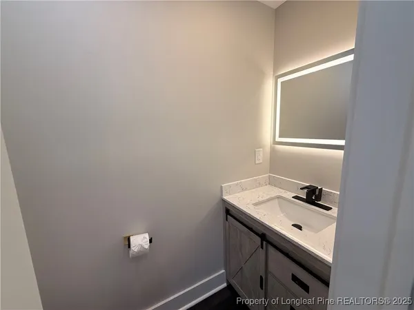 a bathroom with a sink a vanity and a window
