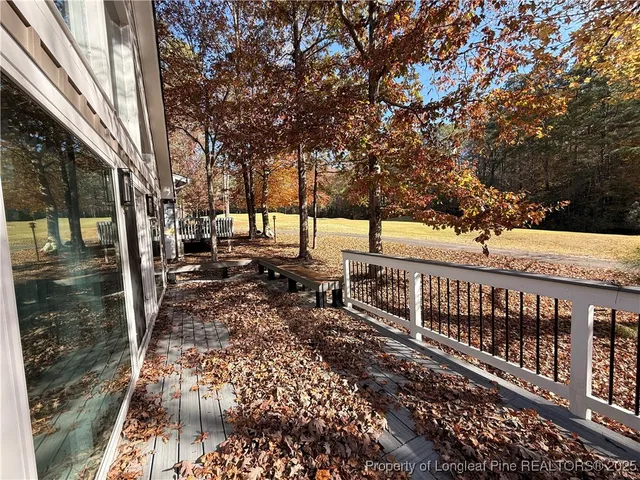 a view of a yard with wooden fence