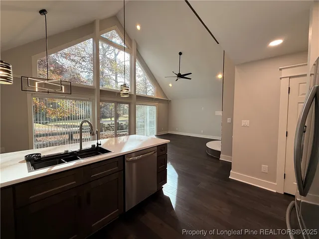 a kitchen with sink refrigerator and window