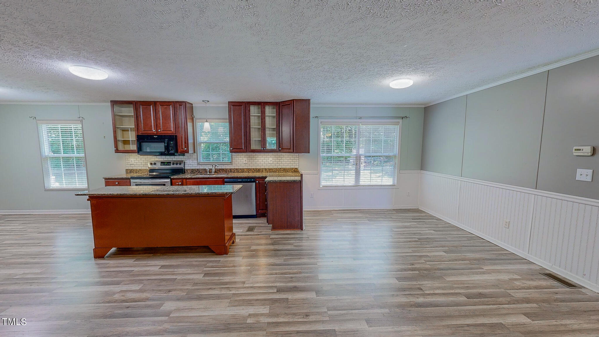 44 Pheasant Way Roxboro, NC 27574 - Photo 11 of 46 a kitchen with stainless steel appliances granite countertop a stove a sink dishwasher and a microwave oven on the wooden floor