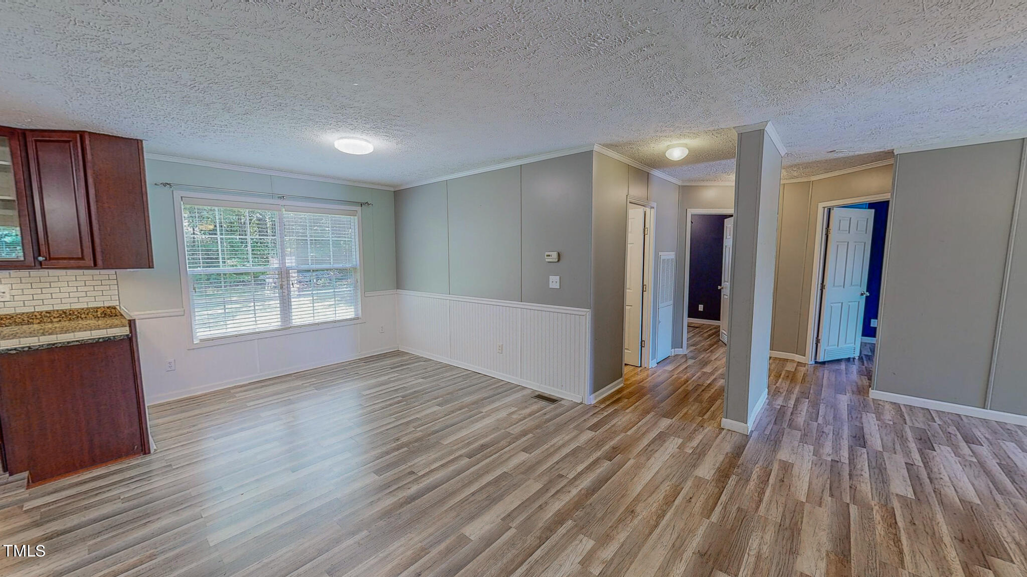 44 Pheasant Way Roxboro, NC 27574 - Photo 12 of 46 a view of an empty room with wooden floor and a window