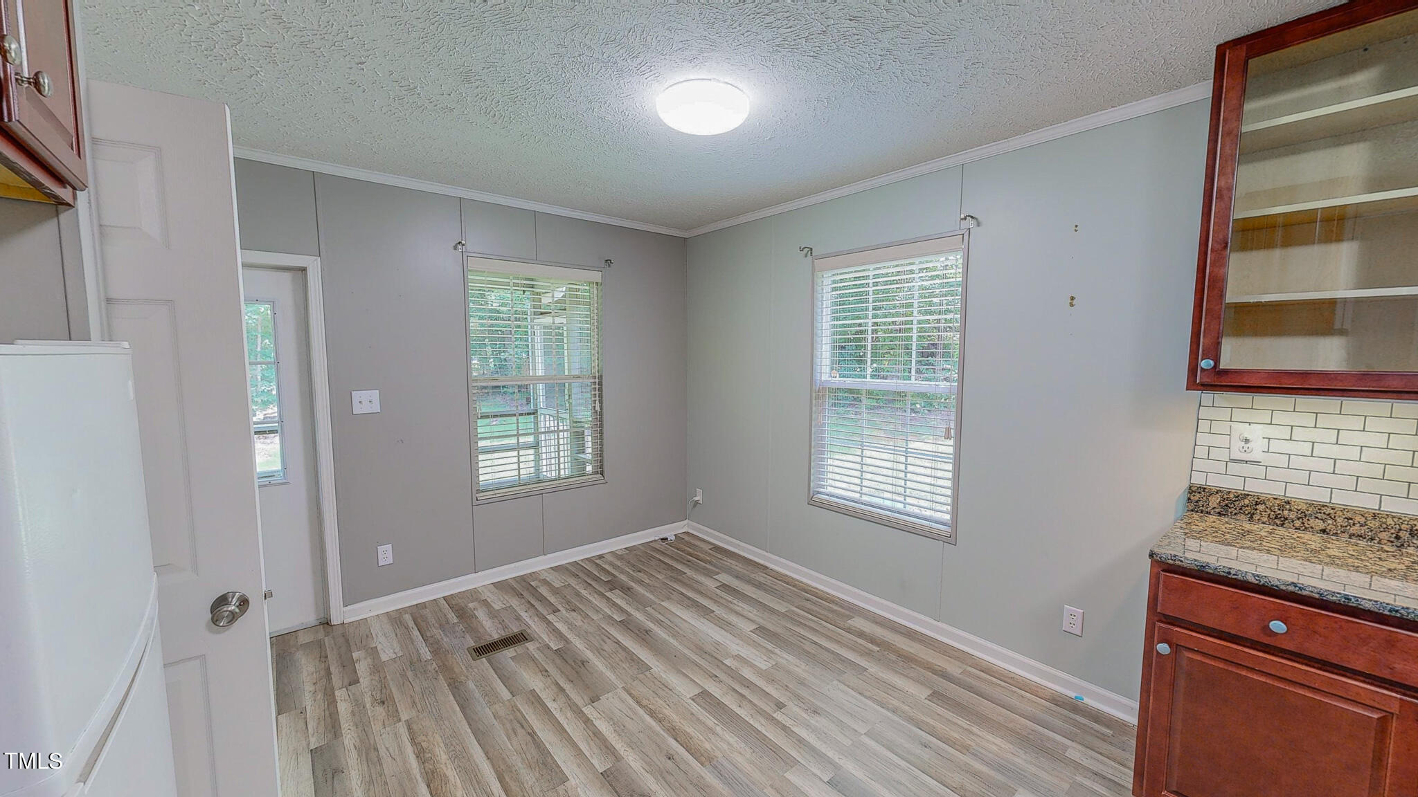 44 Pheasant Way Roxboro, NC 27574 - Photo 13 of 46 a view of an empty room with a window and wooden floor