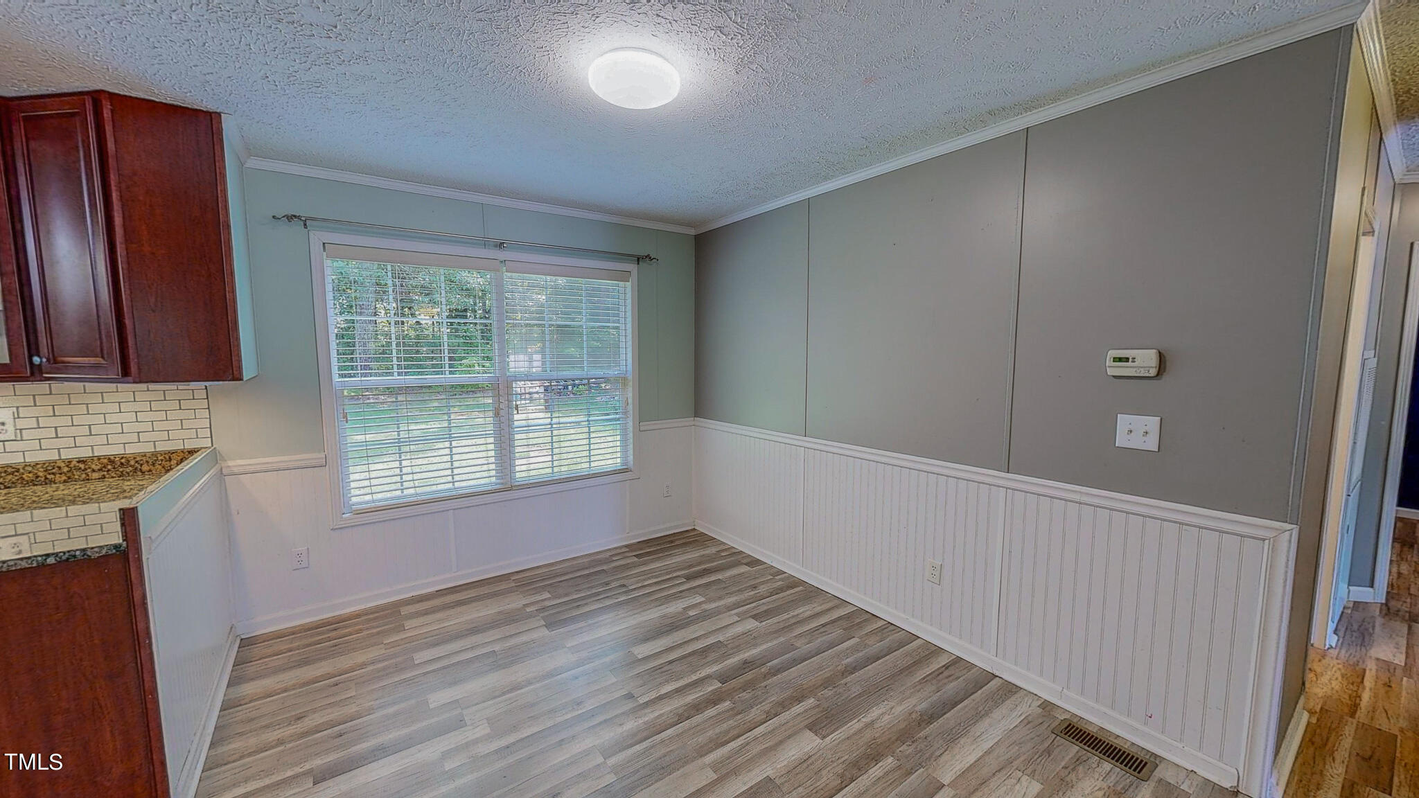 44 Pheasant Way Roxboro, NC 27574 - Photo 15 of 46 a view of an empty room with wooden floor and a window
