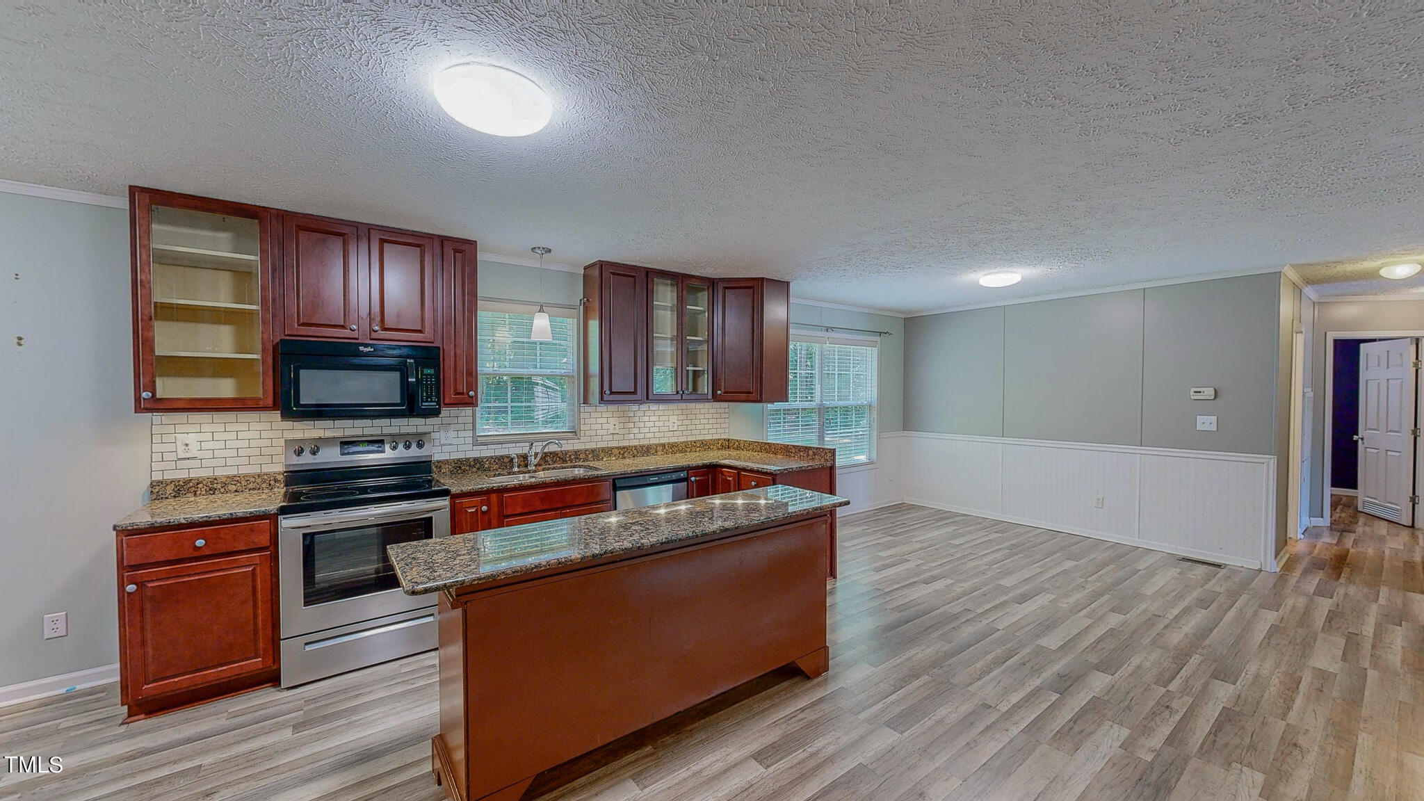 44 Pheasant Way Roxboro, NC 27574 - Photo 18 of 46 a kitchen with stainless steel appliances granite countertop a stove a sink and a microwave