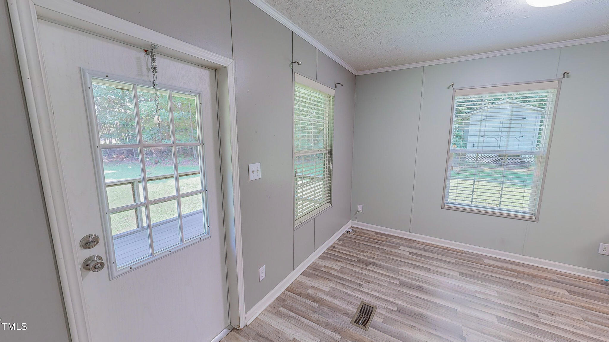 44 Pheasant Way Roxboro, NC 27574 - Photo 21 of 46 a view of an empty room with wooden floor and a window