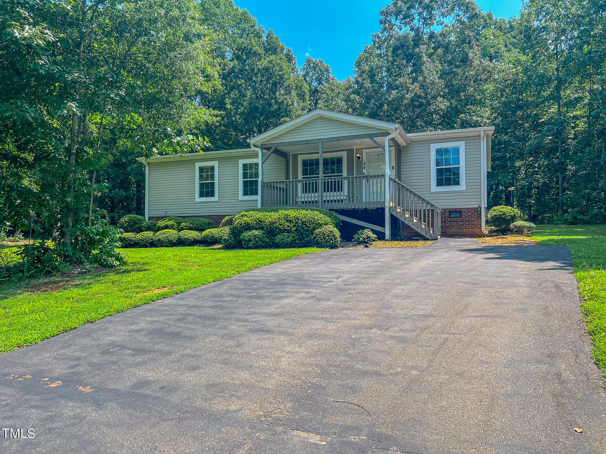 44 Pheasant Way Roxboro, NC 27574 - Photo 22 of 46 a front view of a house with a yard and trees