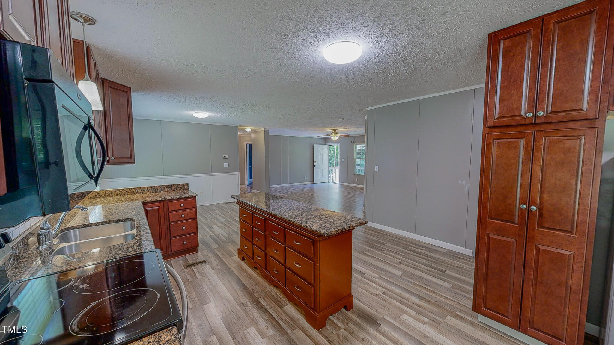44 Pheasant Way Roxboro, NC 27574 - Photo 28 of 46 a kitchen with granite countertop a sink cabinets and stainless steel appliances