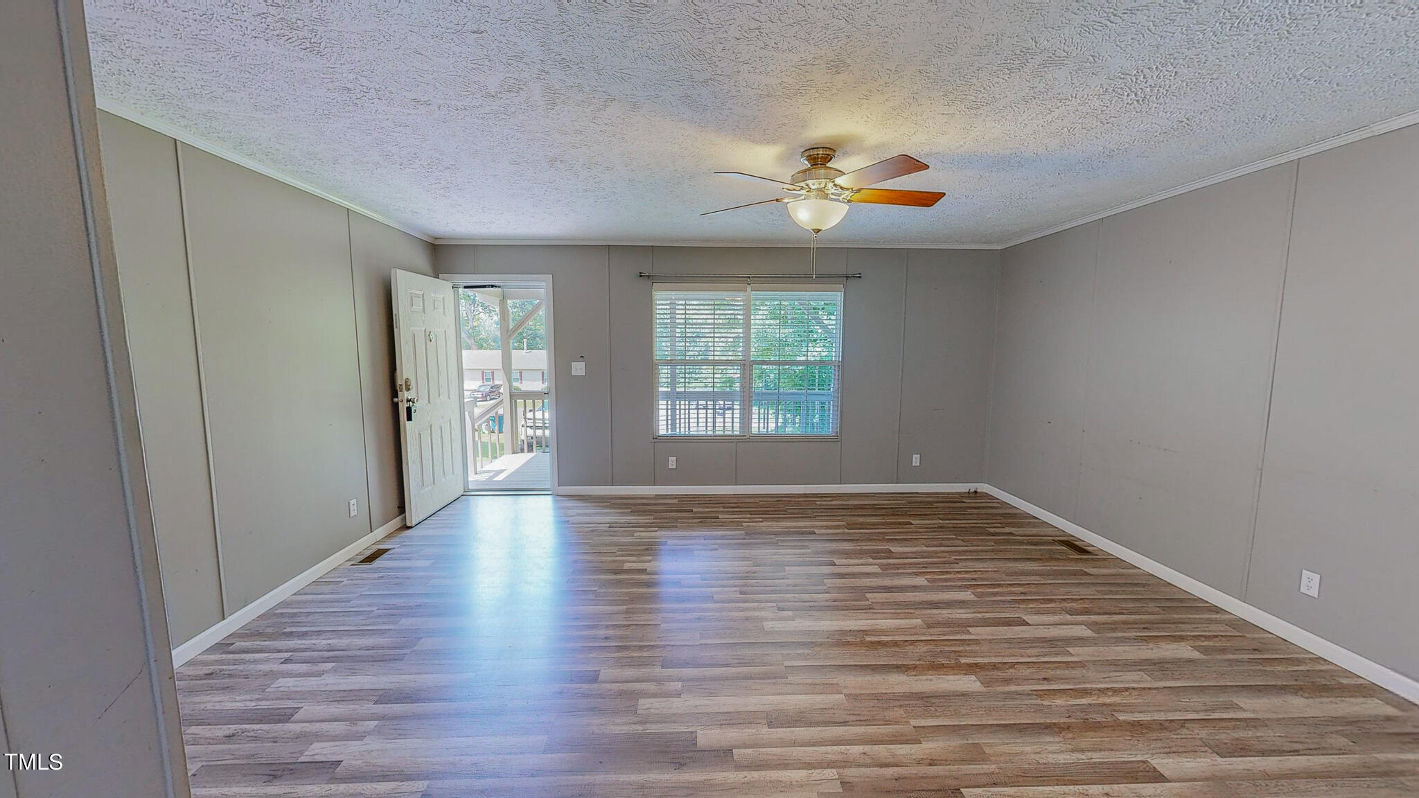 44 Pheasant Way Roxboro, NC 27574 - Photo 29 of 46 a view of an empty room with wooden floor and a window