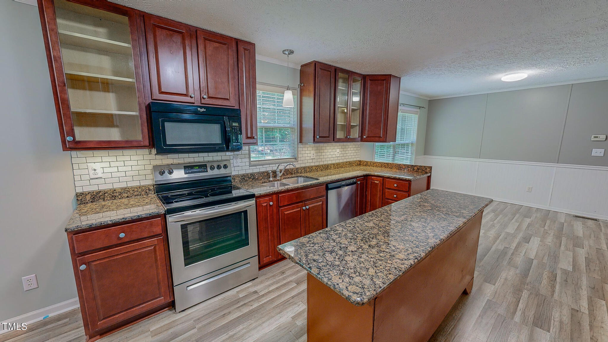 44 Pheasant Way Roxboro, NC 27574 - Photo 3 of 46 a kitchen with stainless steel appliances granite countertop a kitchen island hardwood floor sink stove and granite counter top