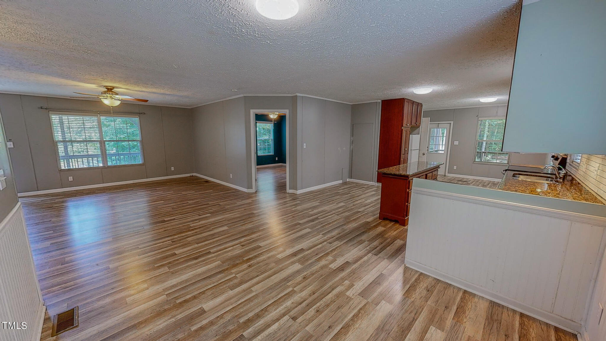 44 Pheasant Way Roxboro, NC 27574 - Photo 31 of 46 an empty room with wooden floor and windows