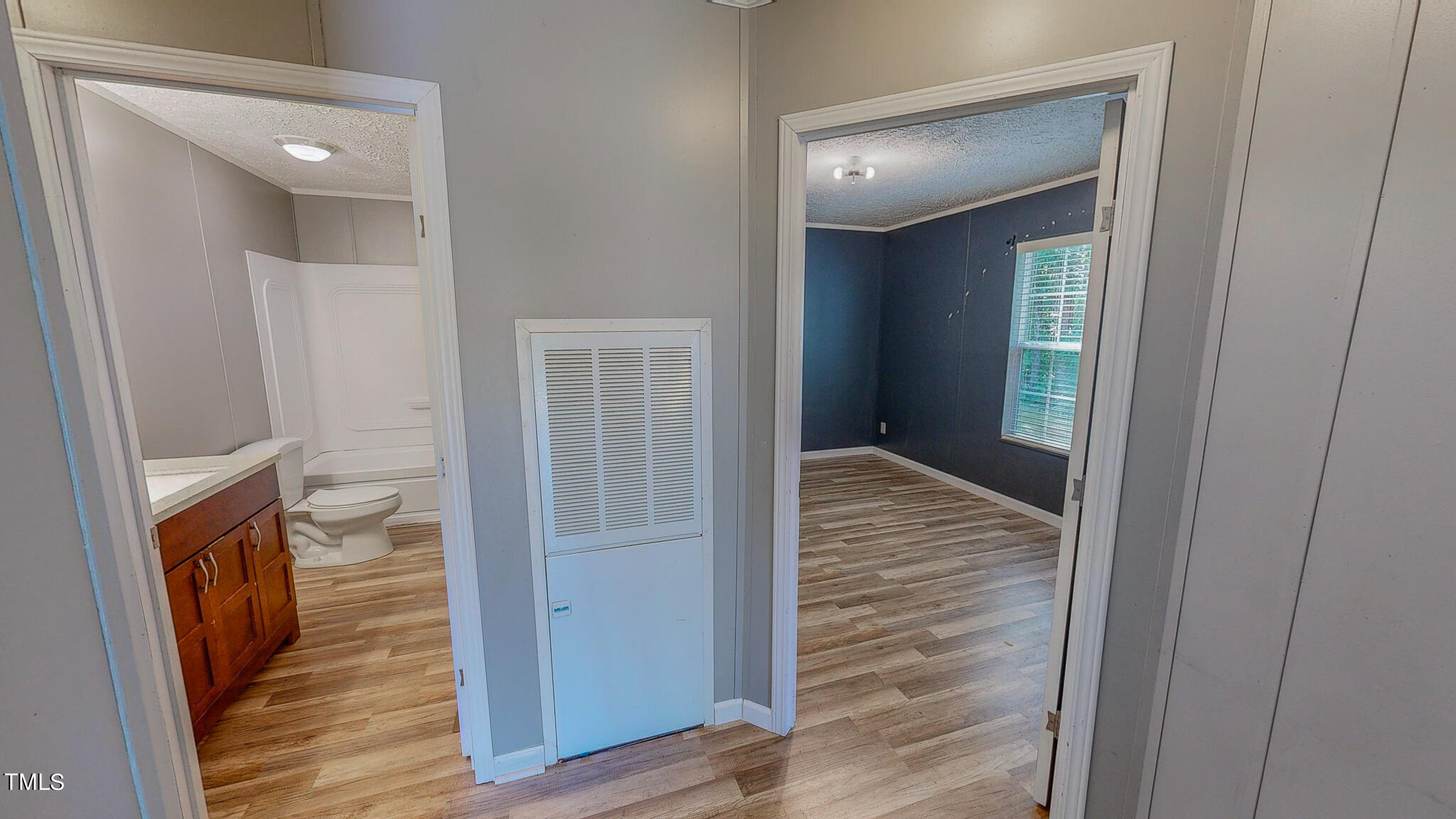44 Pheasant Way Roxboro, NC 27574 - Photo 38 of 46 a view of a hallway with wooden floor and staircase