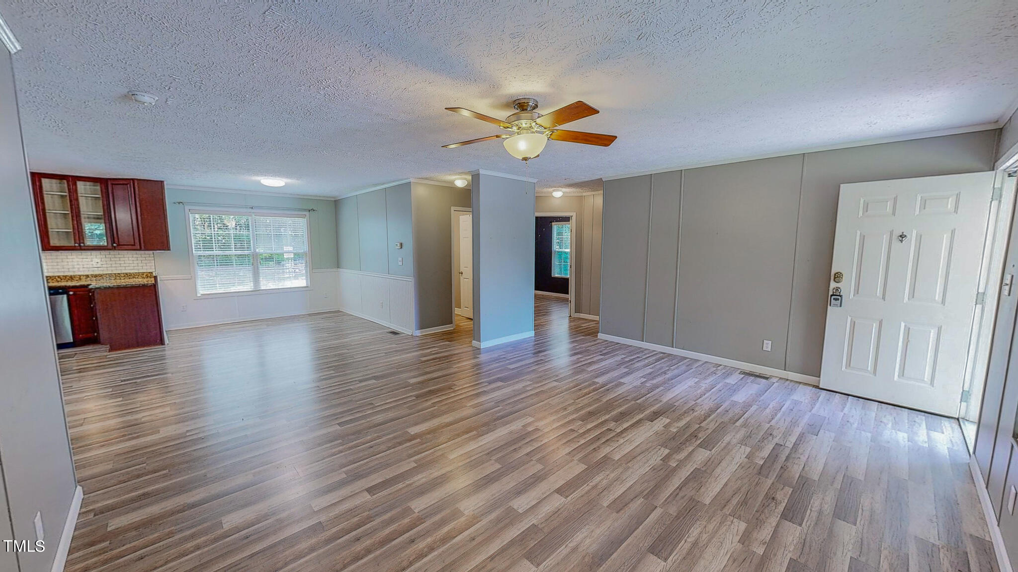 44 Pheasant Way Roxboro, NC 27574 - Photo 9 of 46 a view of an empty room with window and wooden floor