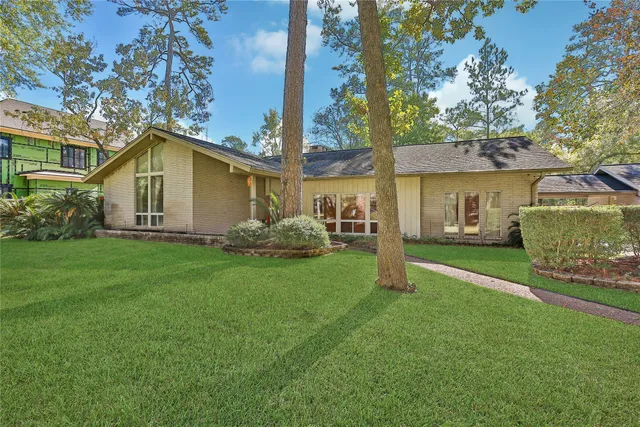 a white house that has a tree in front of it