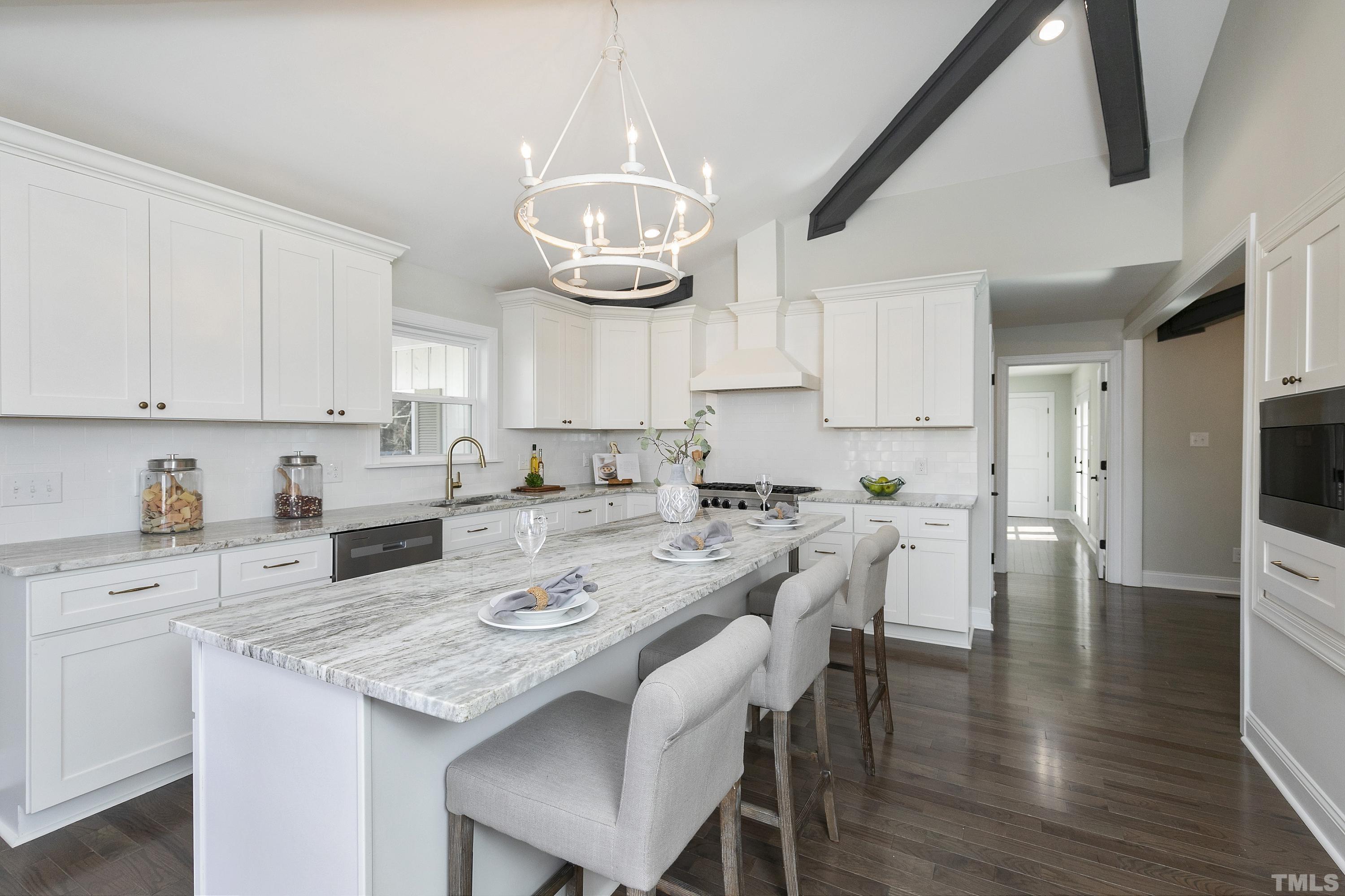 5413 Edington Lane Raleigh, NC 27604 - Photo 13 of 59 a kitchen with stainless steel appliances kitchen island granite countertop a table chairs and a refrigerator